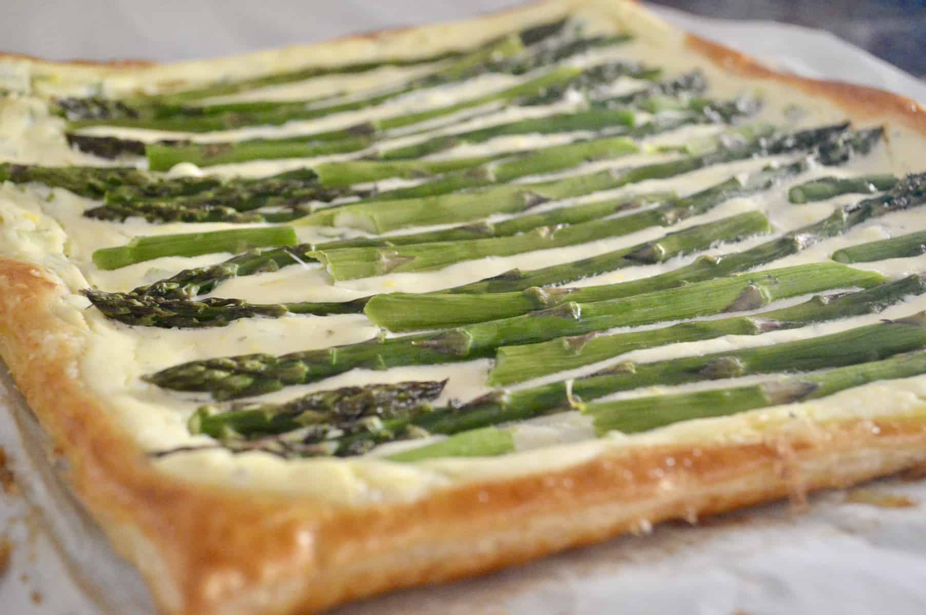 Asparagus Tart with Ricotta and Lemon is made with puff pastry and is an easy recipe for an appetizer or side dish. Great party food for baby or bridal showers, or served on the holidays. #asparagus #tart #ricotta #puffpastry #thanksgivingsidedish #christmassidedish #easter #appetizer #partyfood #appetizerforparty #easyrecipe #brunch #breakfast