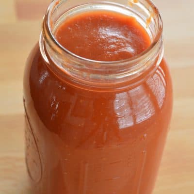 mason jar with marinara sauce in it.