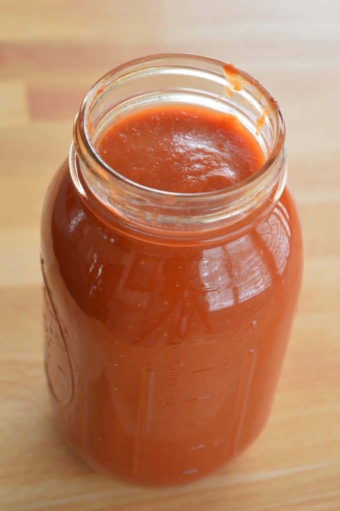 mason jar with marinara sauce in it.