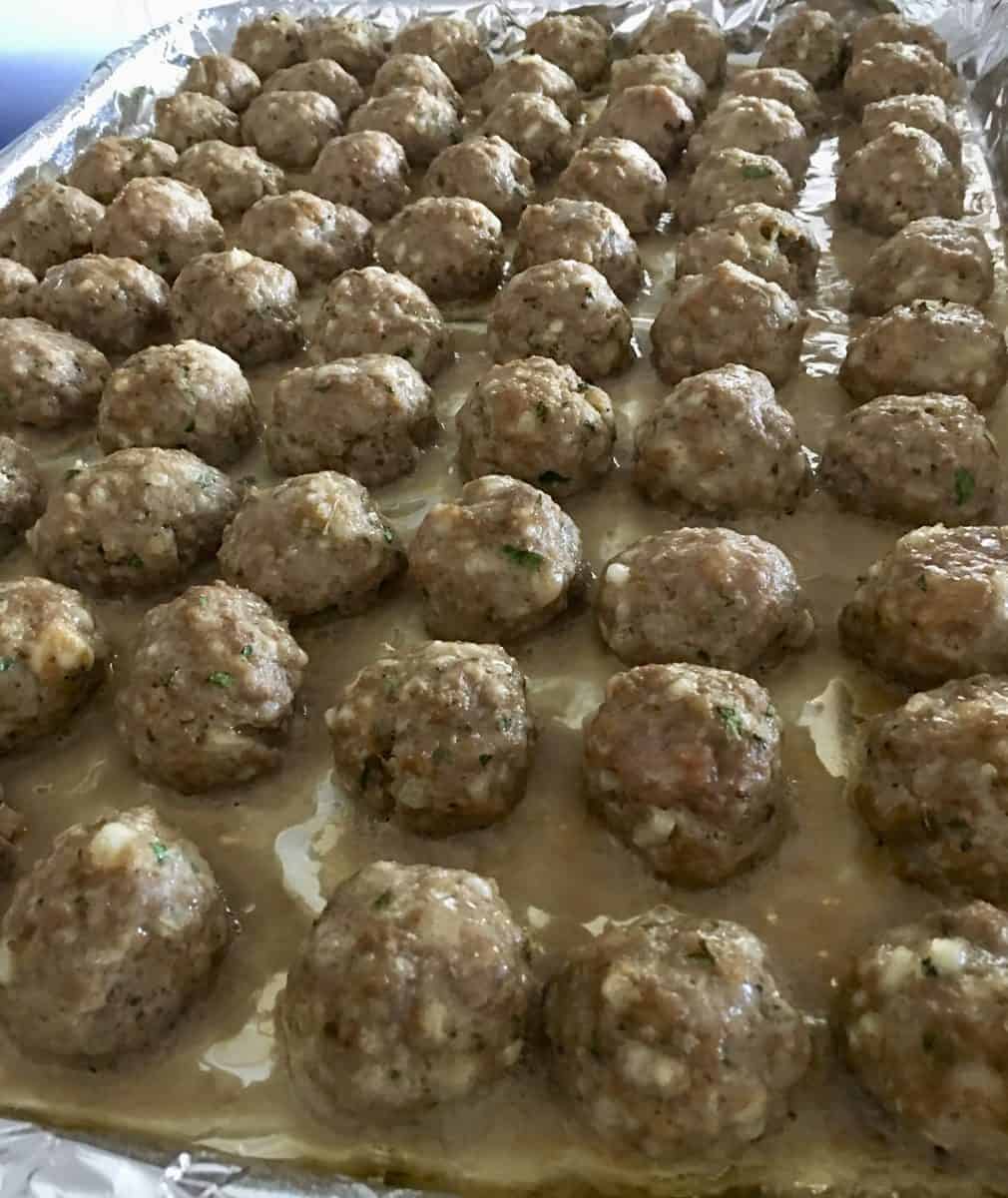 baked meatballs on a foil lined baking sheet