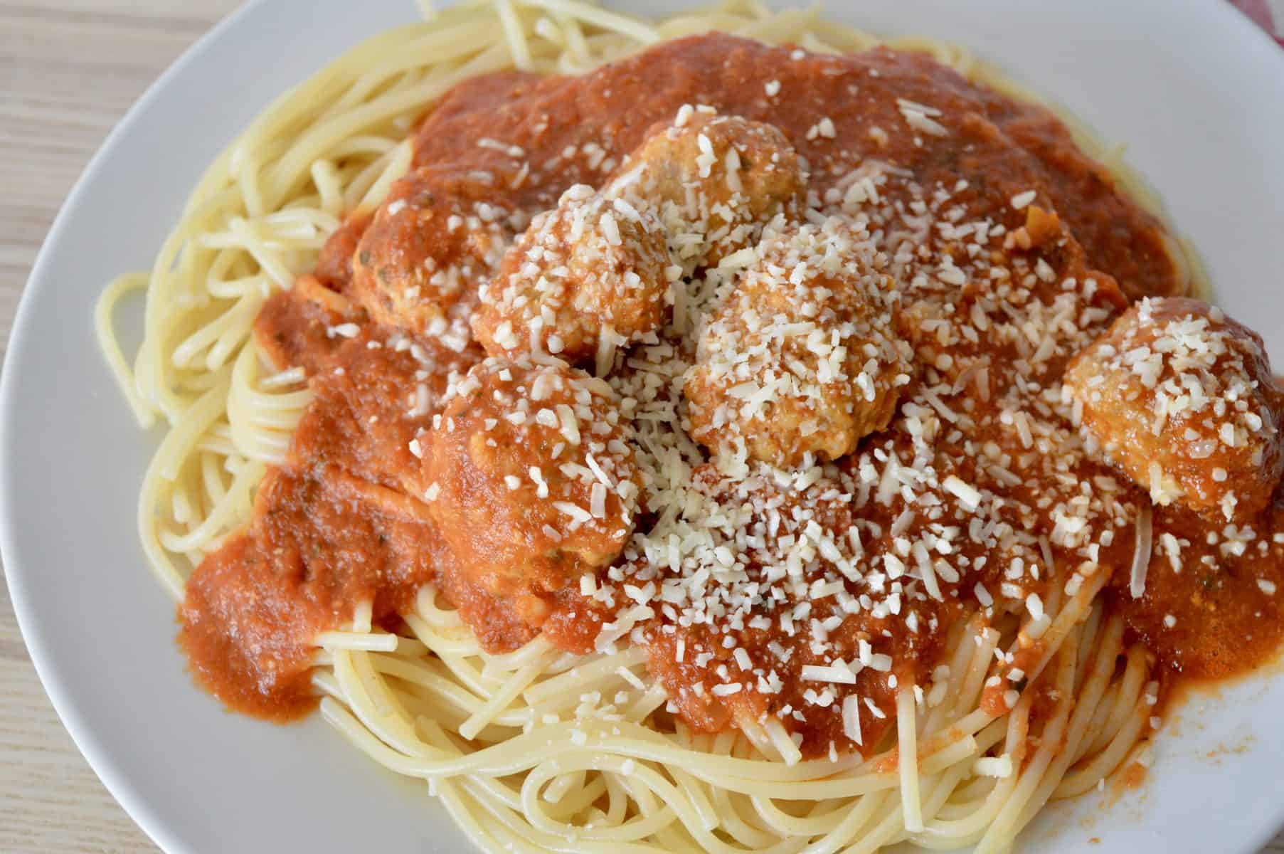 meatballs and spaghetti on a a white plate. 