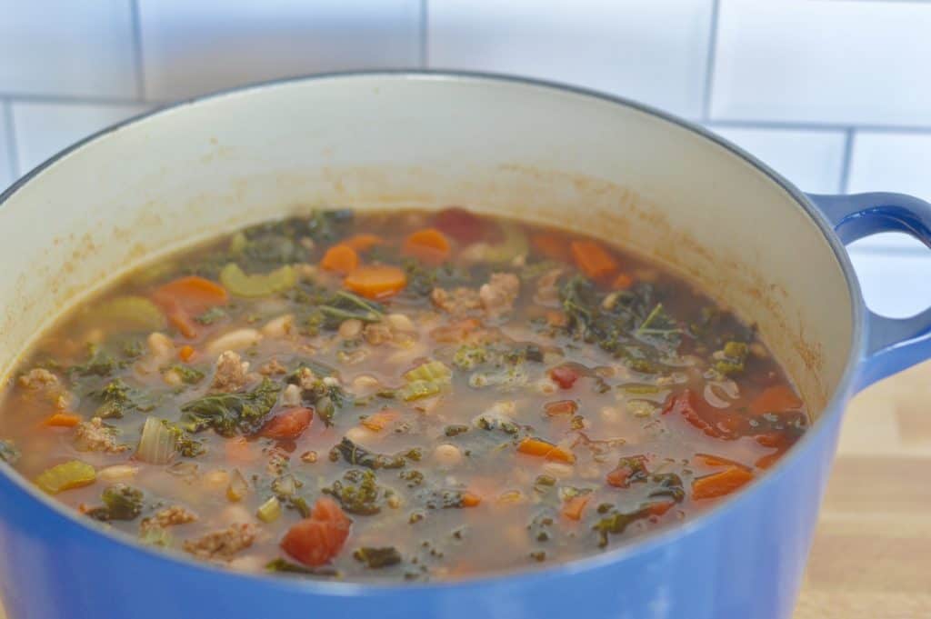large blue dutch oven full Italian tuscan stew.