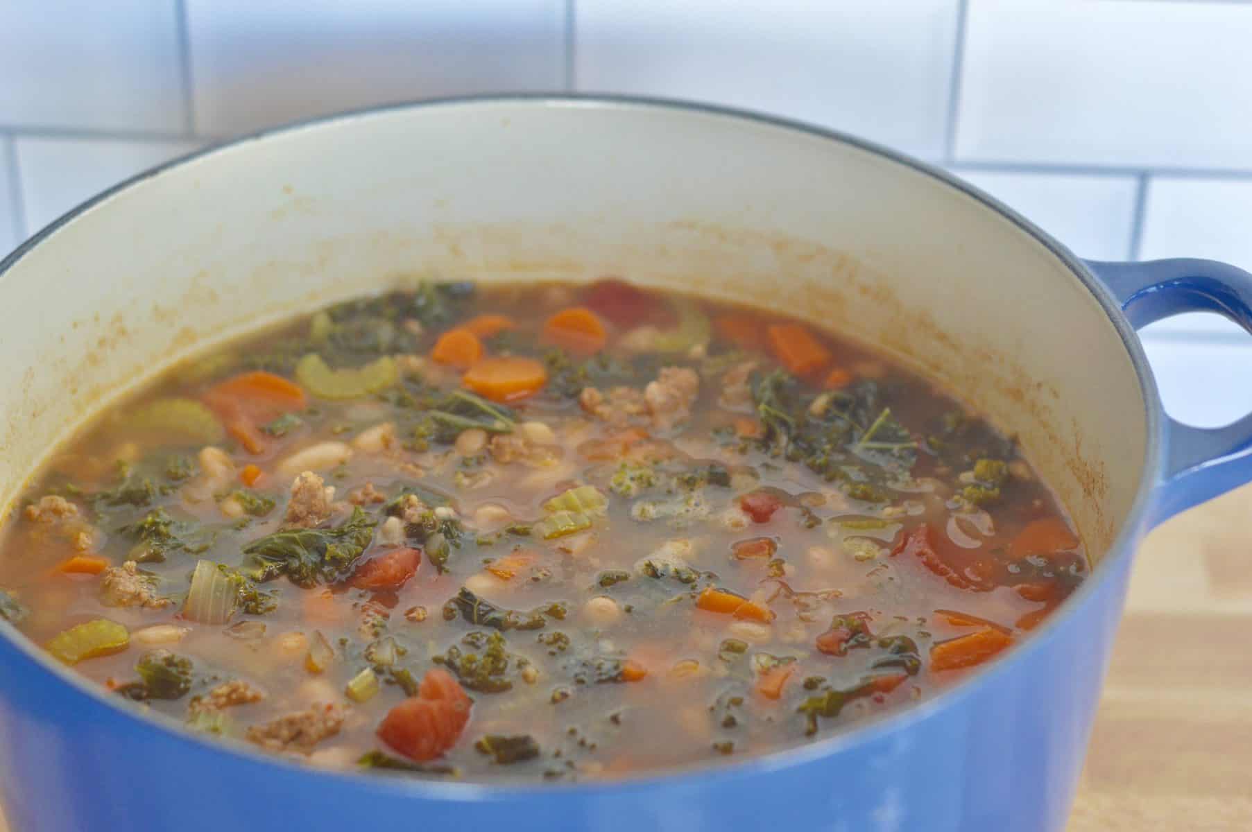 large blue dutch oven full Italian tuscan stew. 