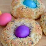 Italian easter bread with sprinkles and a colored egg in the center.