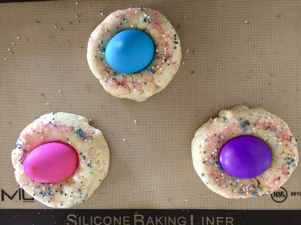 easter bread dough with colored eggs in the middle.