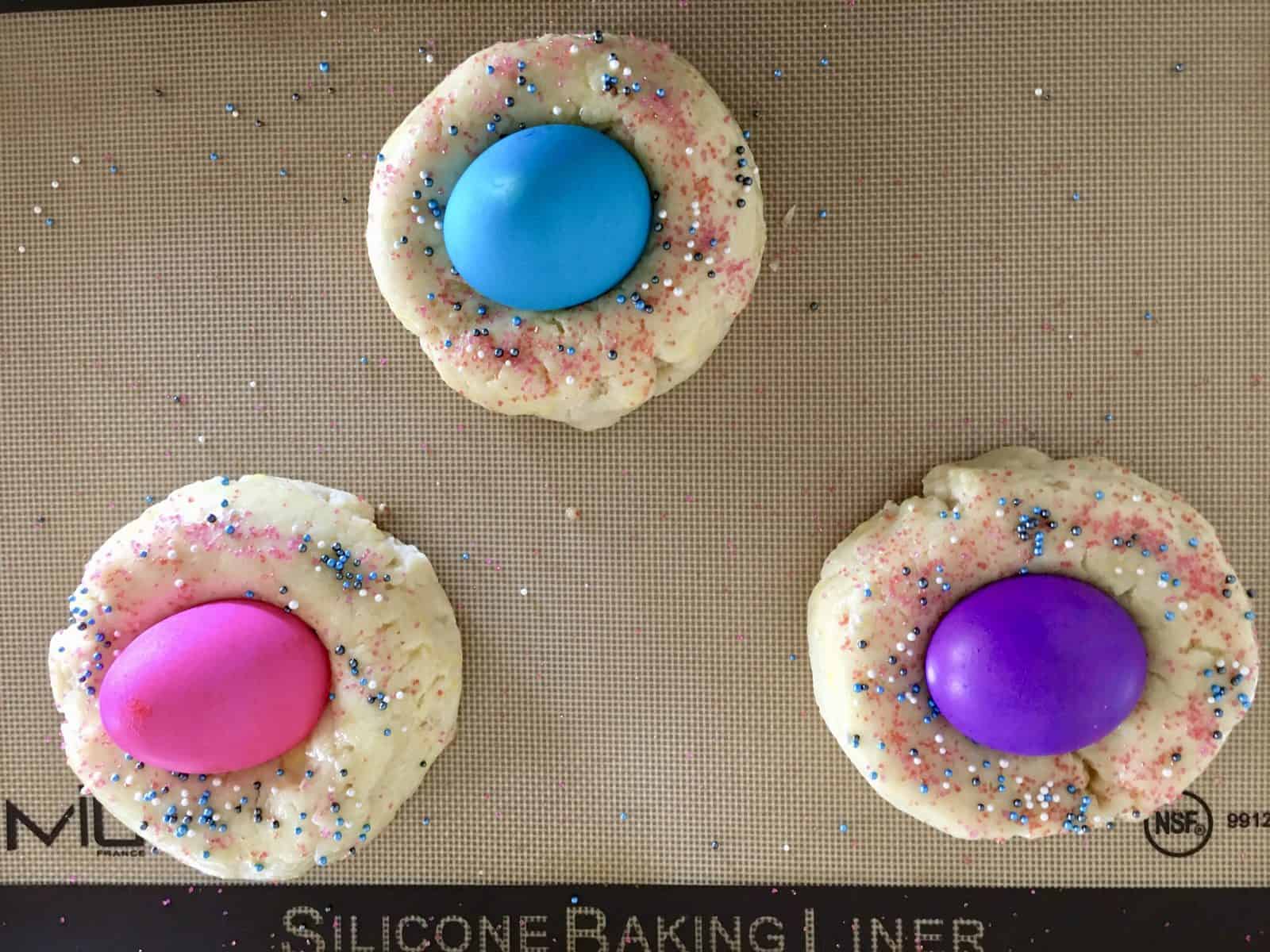 easter bread dough with colored eggs in the middle. 