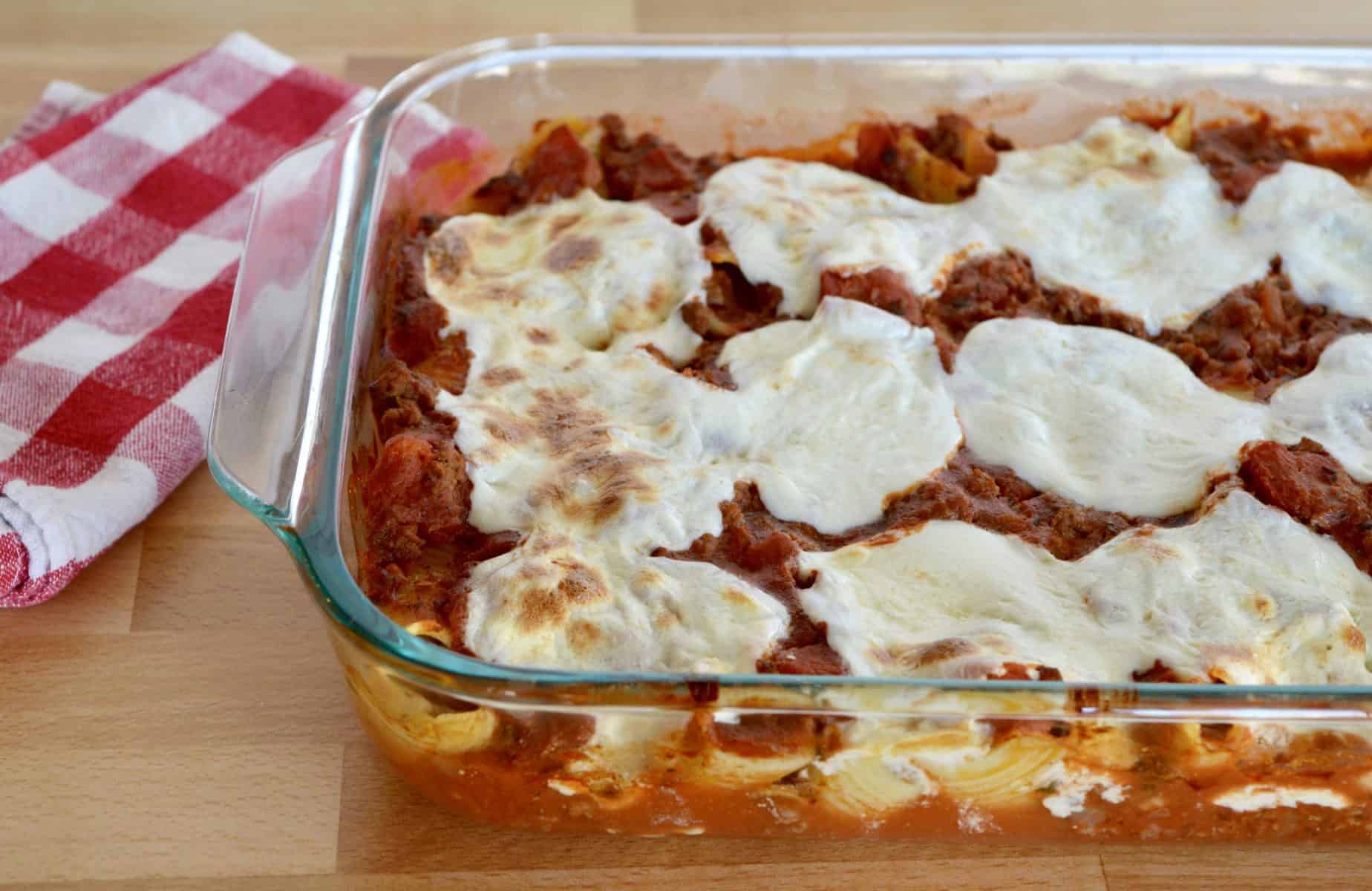 Cheese beef Stuffed Shells in a glass baking dish.
