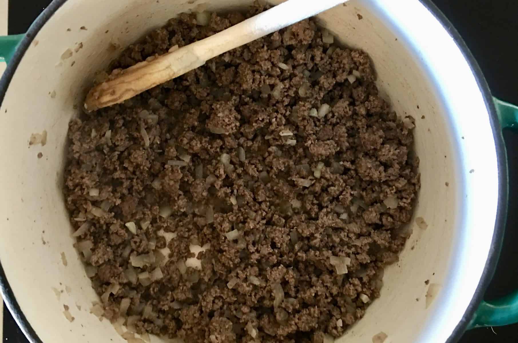 ground beef and onions in a pan. 