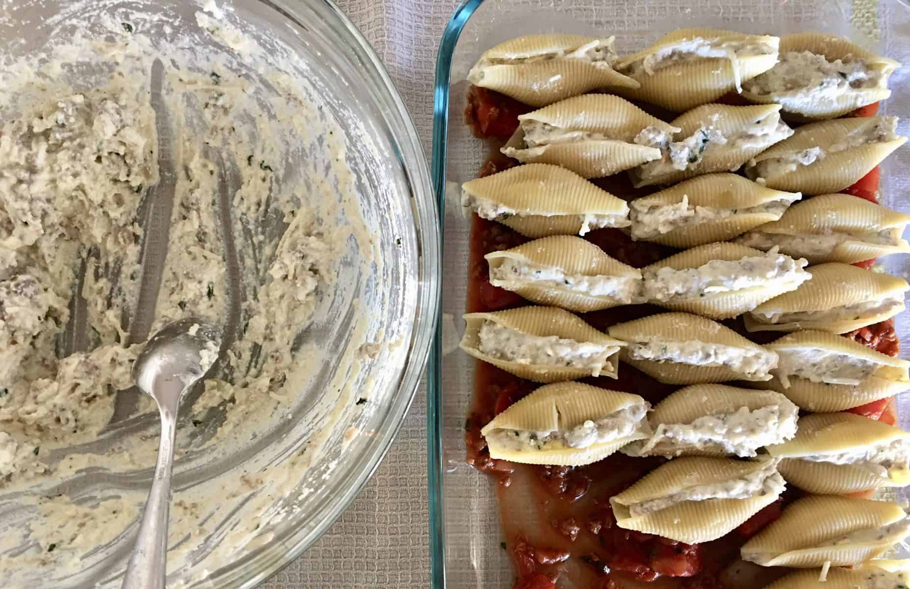 stuffed shells in baking dish with bowl of ricotta meat mixture next to it. 