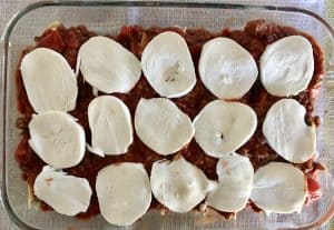 thin slices of mozzarella cheese cover the top of the cheese beef stuffed shells.