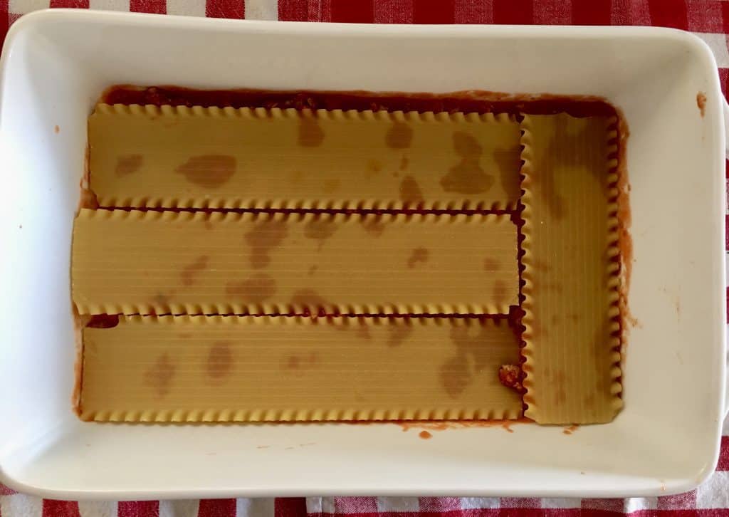 no-bake lasagna noodles layered overtop of the turkey meat sauce in the baking dish.