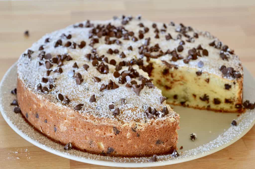 Chocolate Chip Ricotta Cake with a slice missing from it.