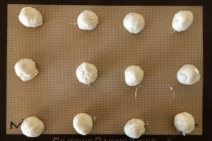 dough balls on a baking sheet .