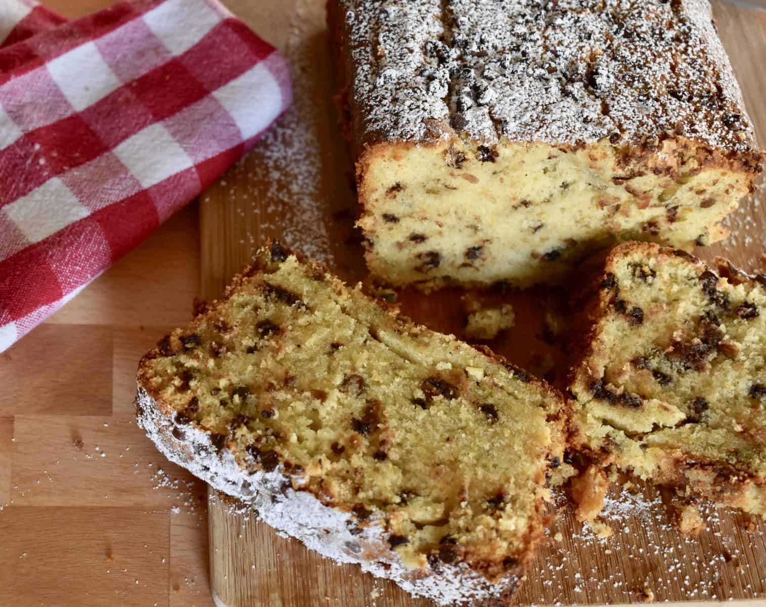 Cannoli Pound Cake on a cutting board with a red and white checkered napkin. 