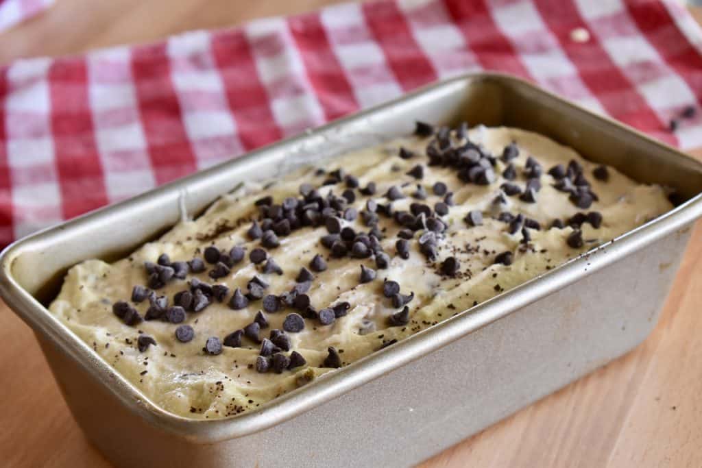 Batter poured into loaf pan with chocolate chips sprinkled on top.