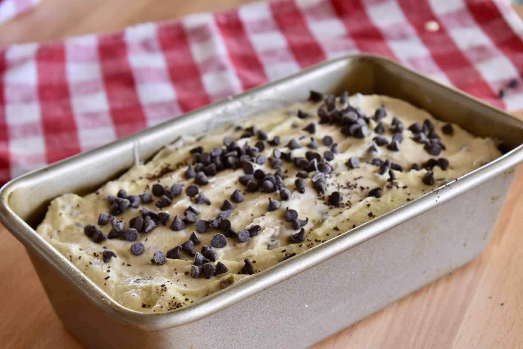 Batter poured into loaf pan with chocolate chips sprinkled on top. 