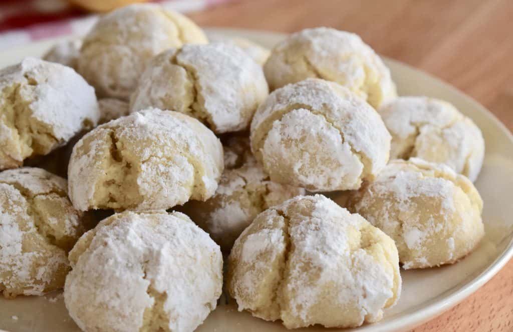 Finished cookies piled on a white plate.