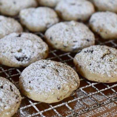 powdered sugar spindled on top of the cooled cookies on a baking rack.
