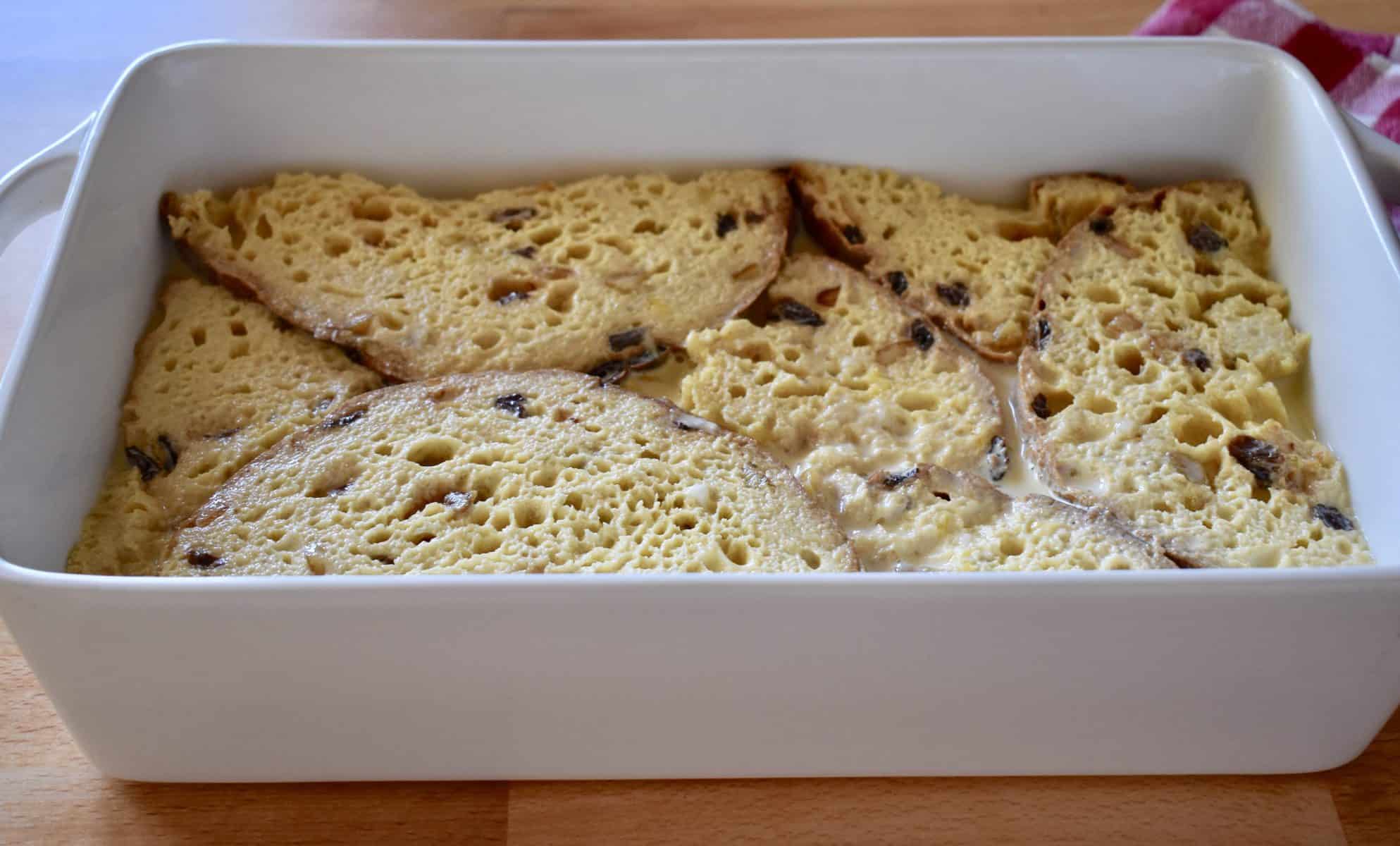 panettone French toast casserole in a white pan ready to bake. 