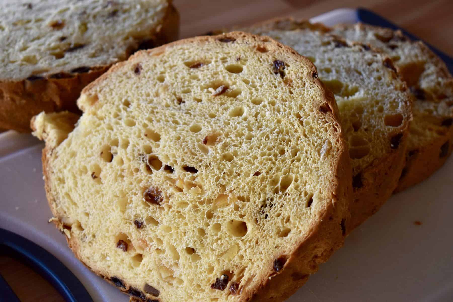 Sliced Panettone on a white cutting board. 