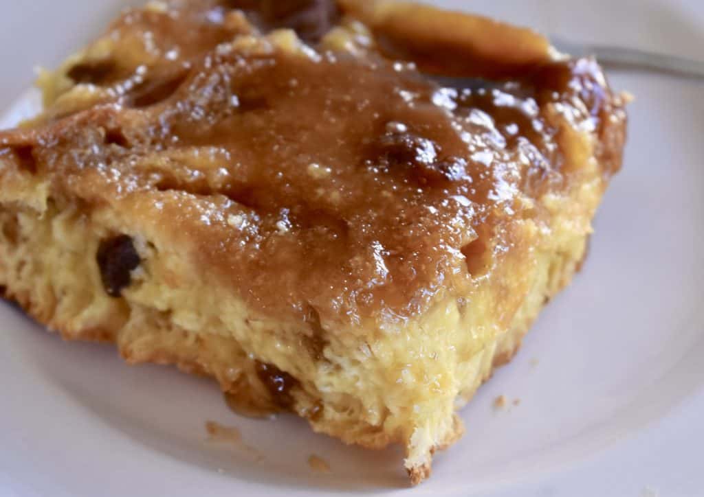 Panettone French Toast Casserole with brown sugar topping on a white plate.