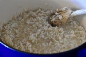 arborio rice almost completely cooked in a pot