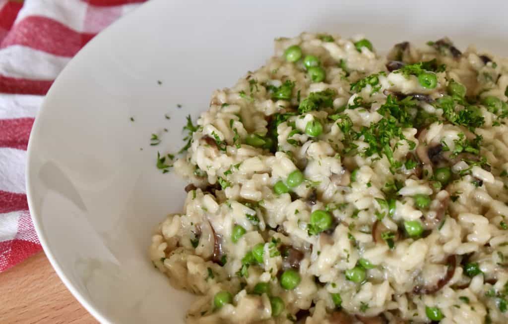 Mushroom Pea Risotto in a white plate.