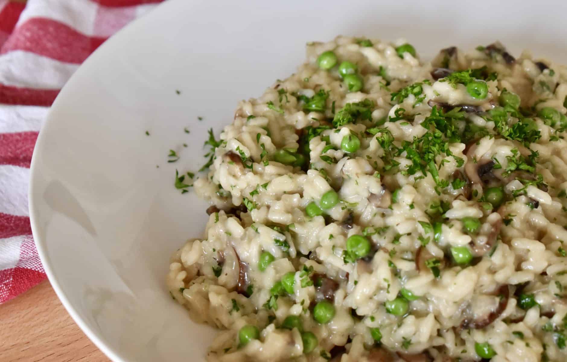 Mushroom Pea Risotto in a white plate. 