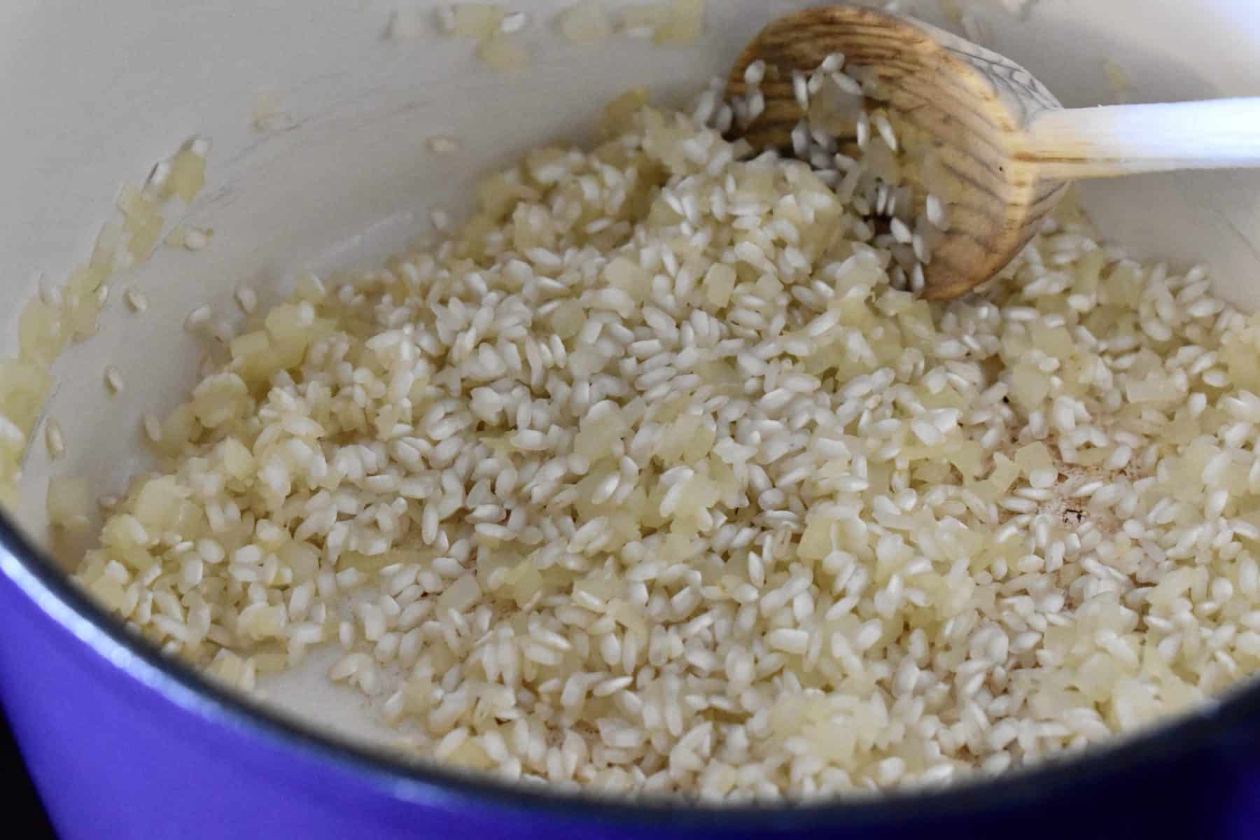 Arborio rice added to the cooked onions. 