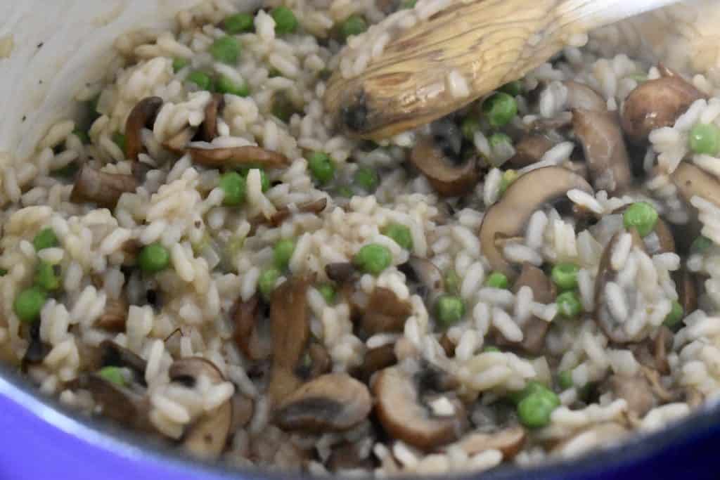 Peas added to the pot of risotto.