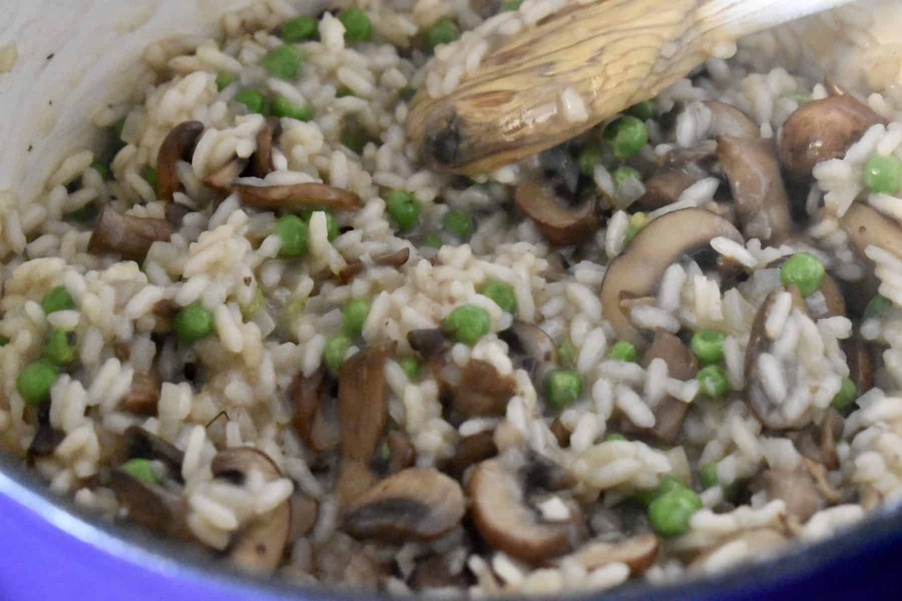 Peas added to the pot of risotto. 