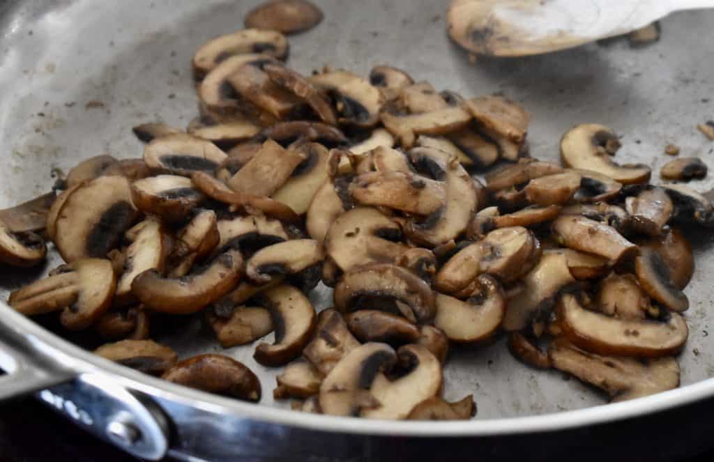 mushrooms cooked down on the stove.