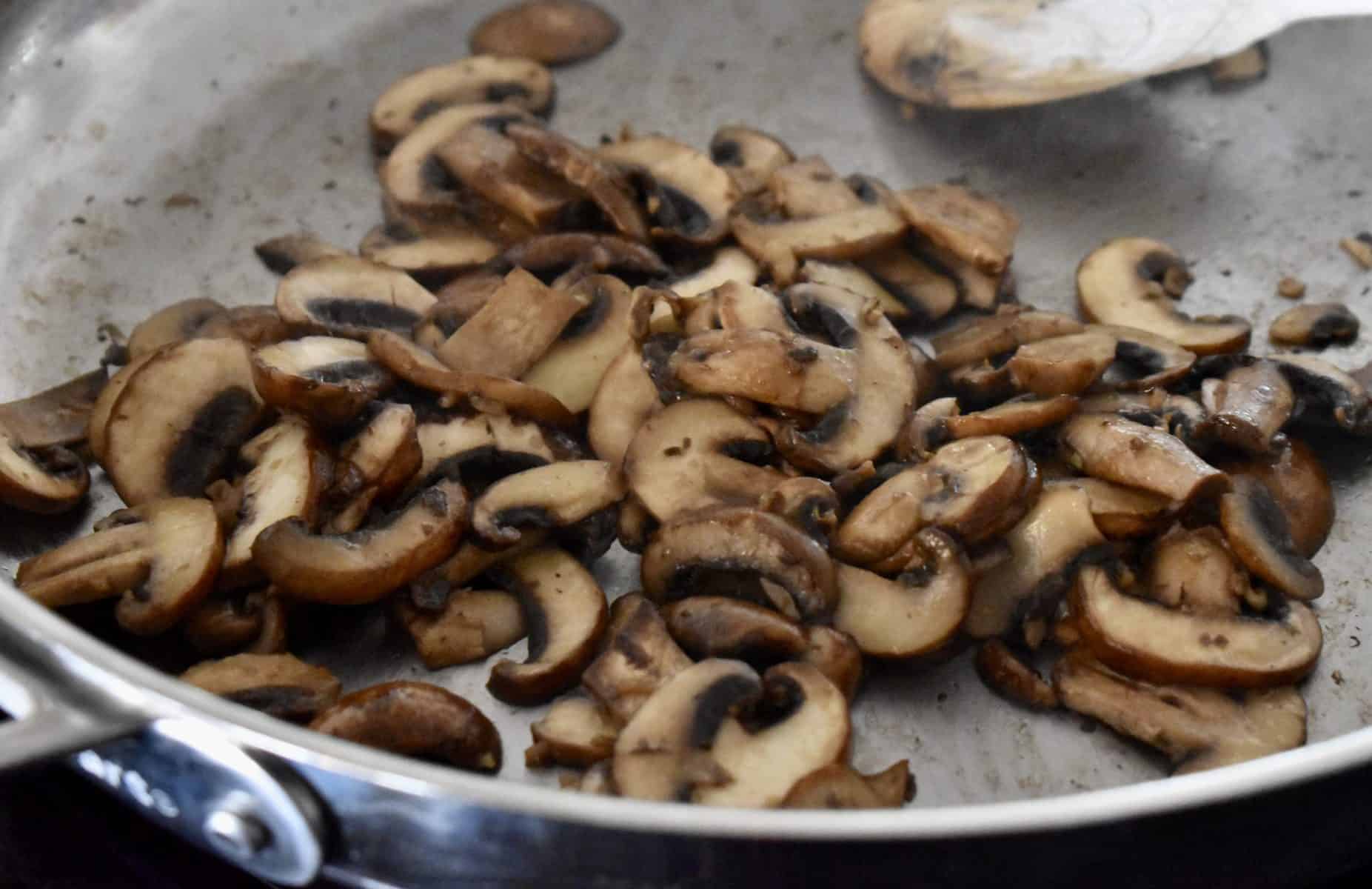 mushrooms cooked down on the stove. 
