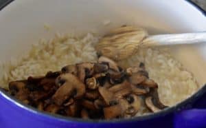Mushrooms added to the pot of arborio rice.