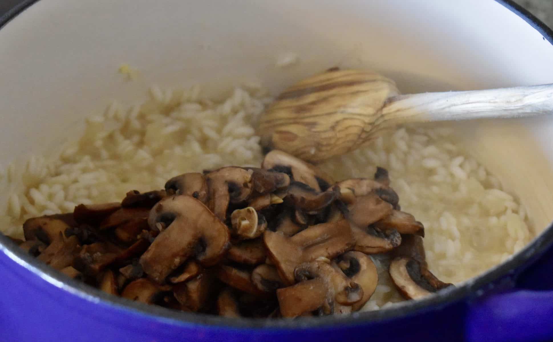 Mushrooms added to the pot of arborio rice. 