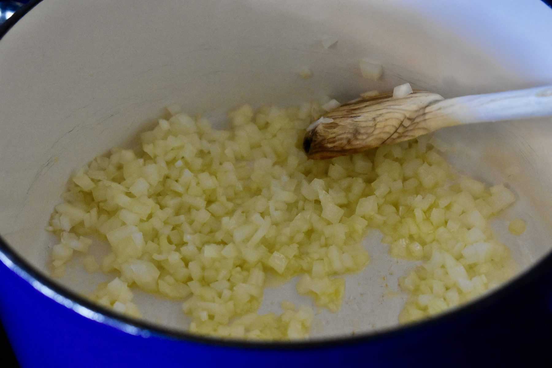 Onions softened in a pot. 