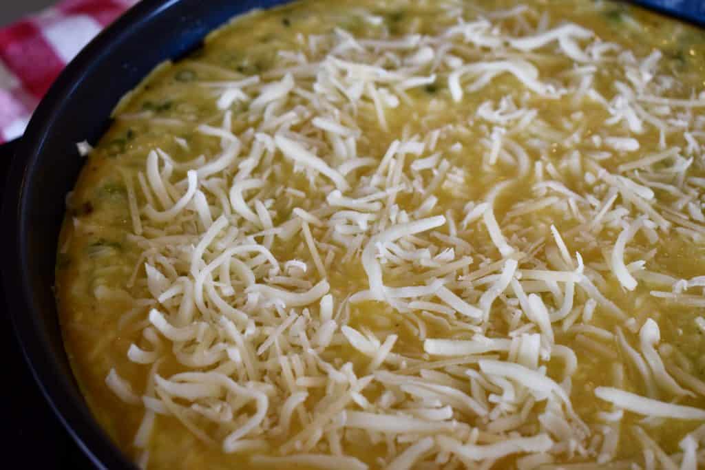 cheese sprinkled over top of the frittata in the pan.
