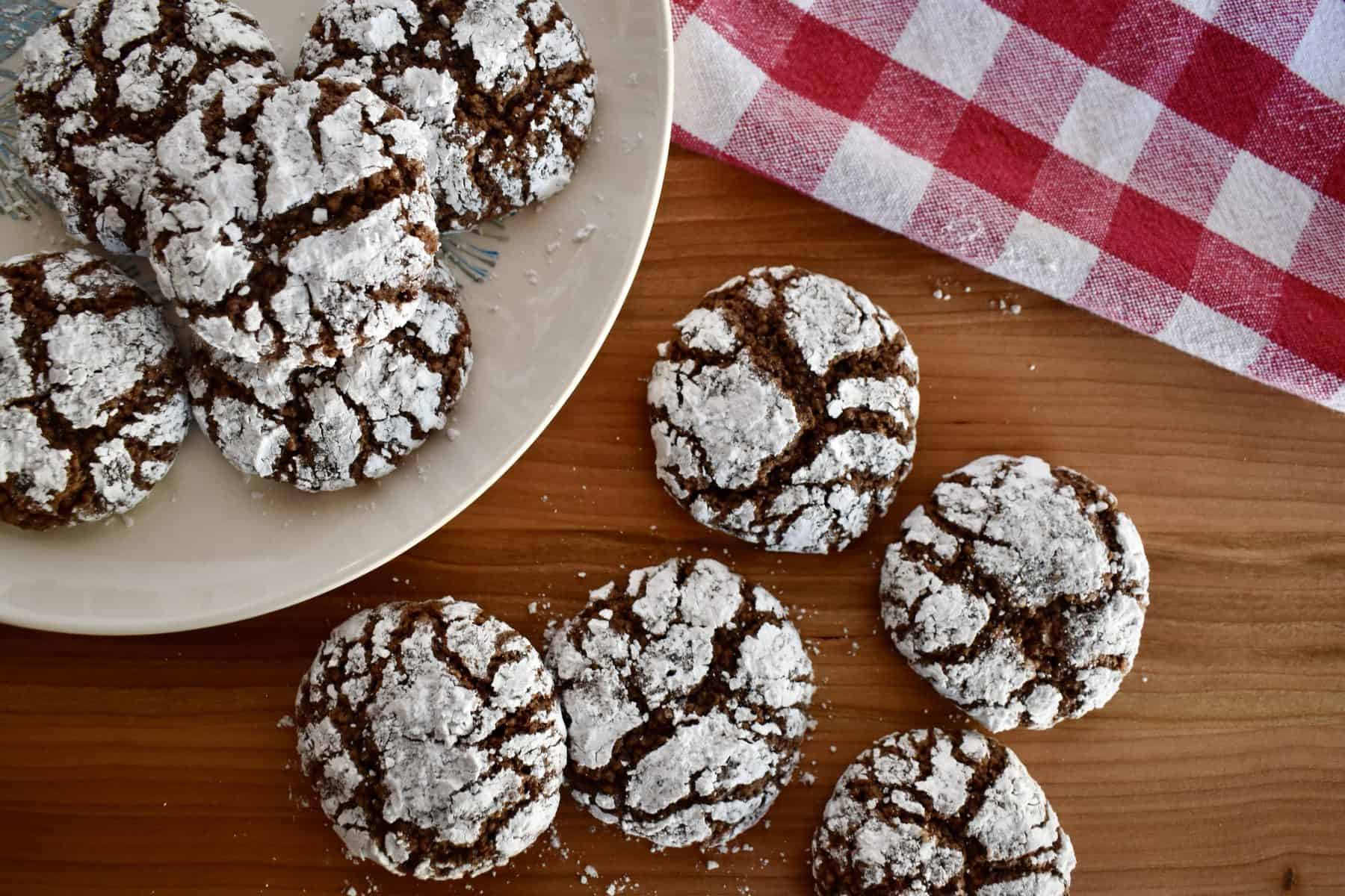 Italian Almond Chocolate Cookies on a wood cutting board with a checkered napkin. 