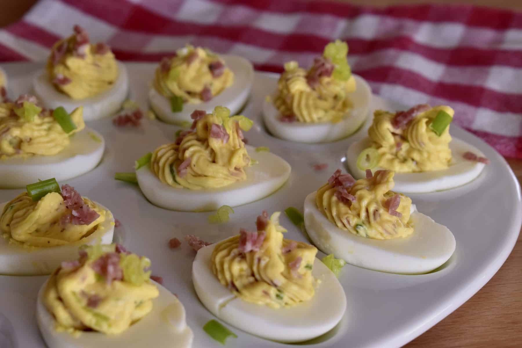 Italian Deviled Eggs on a white serving platter.