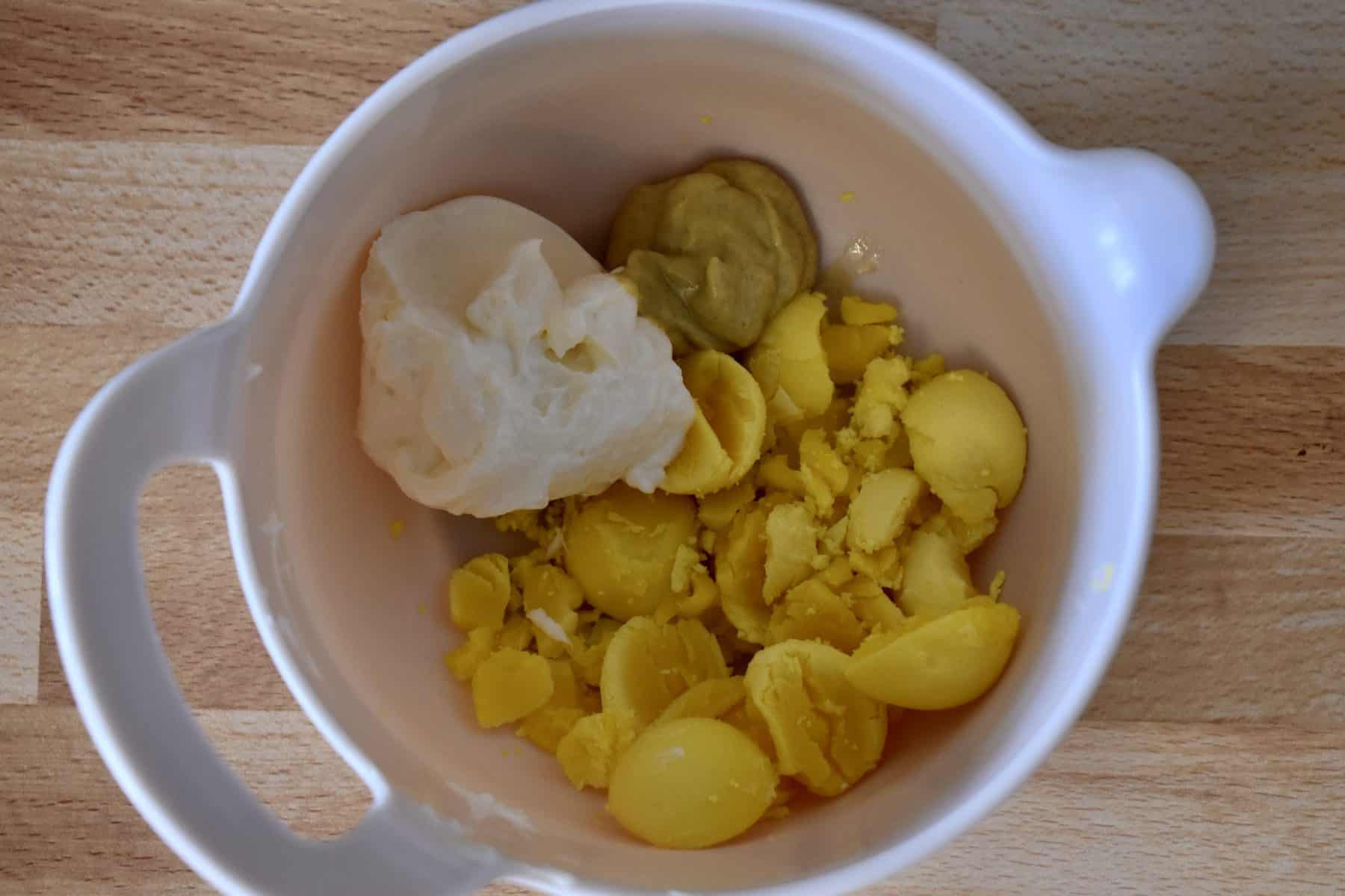 egg yolks, mayo, and dijon in a mixing bowl.