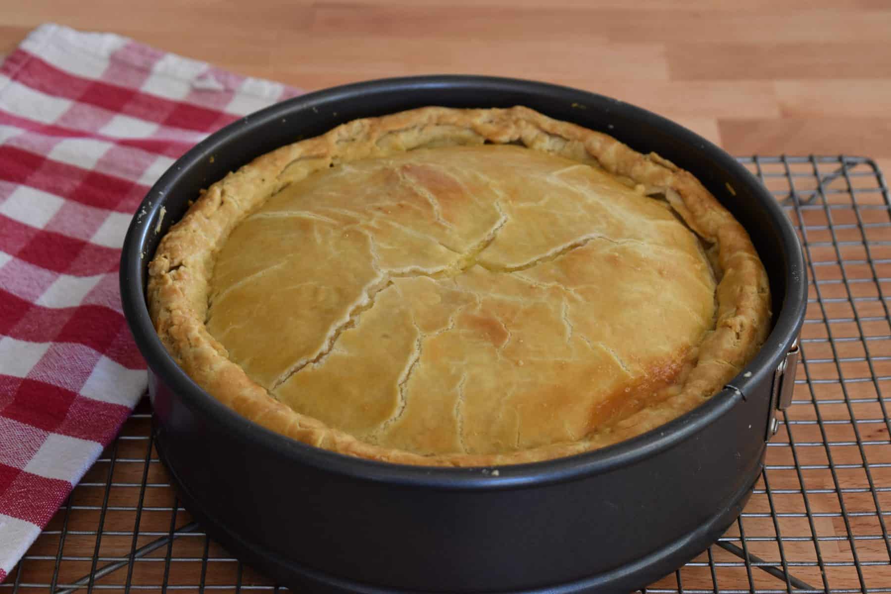 Italian Easter Pie in a springform pan on a cooling rack. 