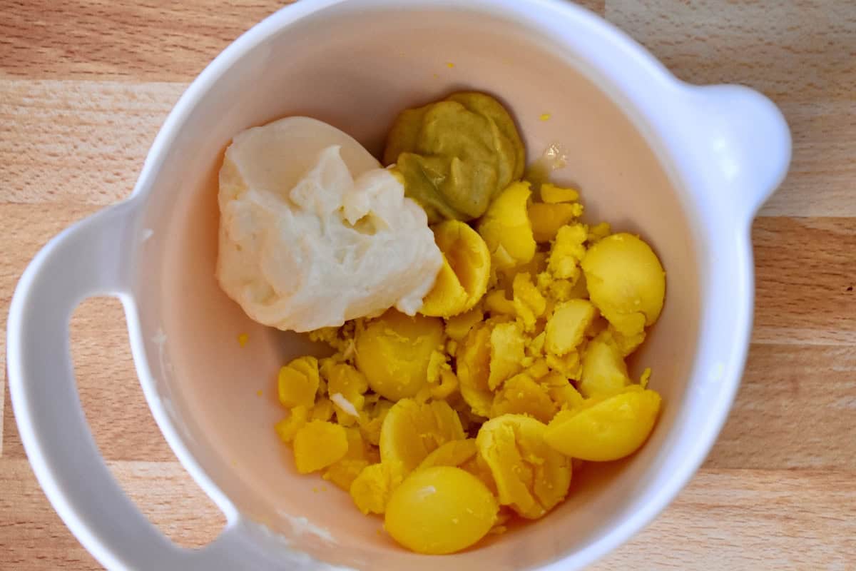 Yolks, mayo, and dijon in a mixing bowl.