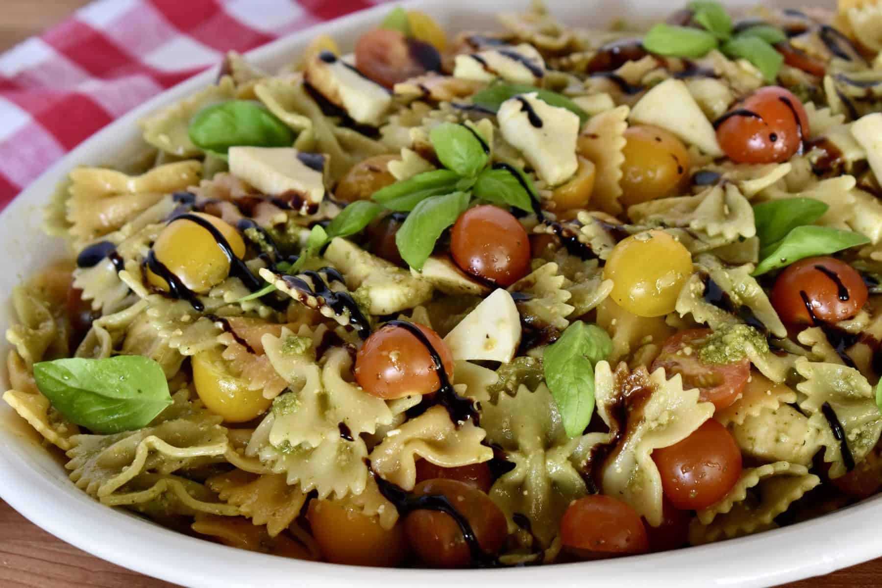 Pesto pasta Salad on a white serving platter. 