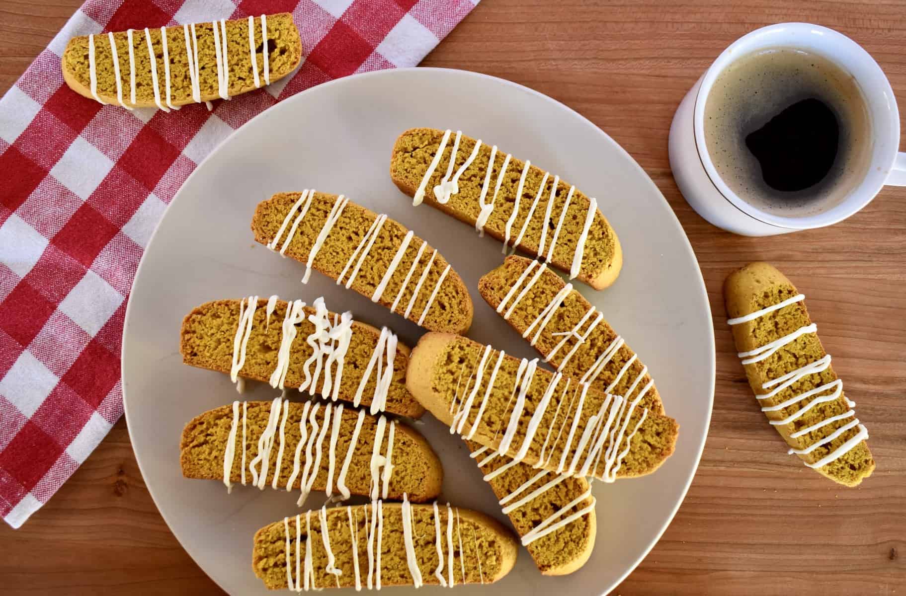 overhead photo of pumpkin biscotti with a cup of black coffee. 