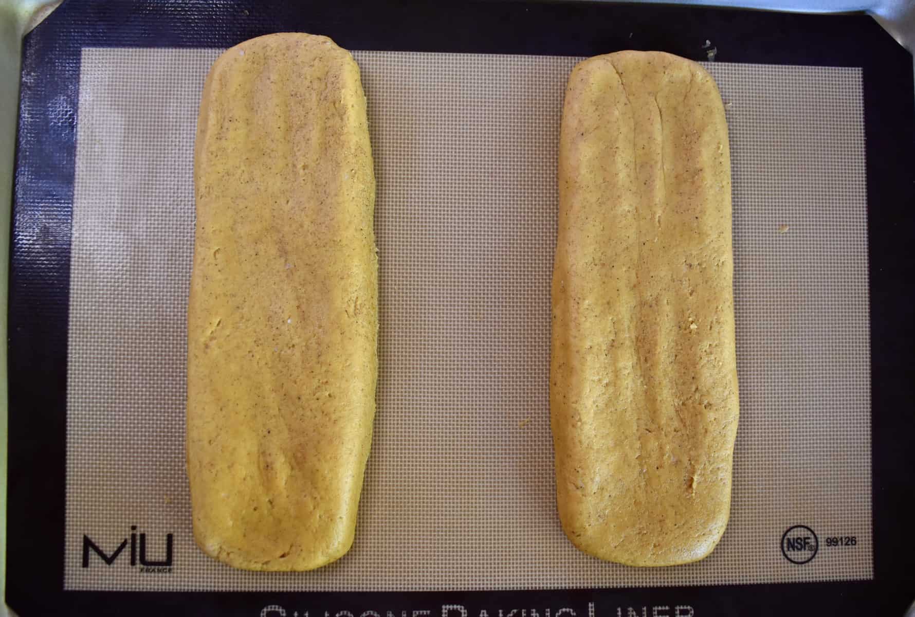 overhead photo of the dough smoothed out into two rectangular pieces. 