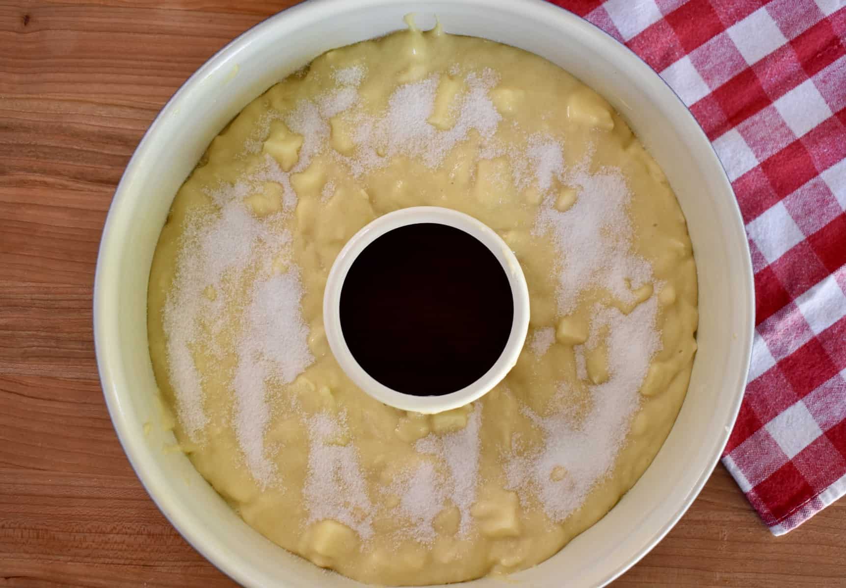 overhead photo of sugar sprinkled over top of the  cake in the Bundt Cake pan. 