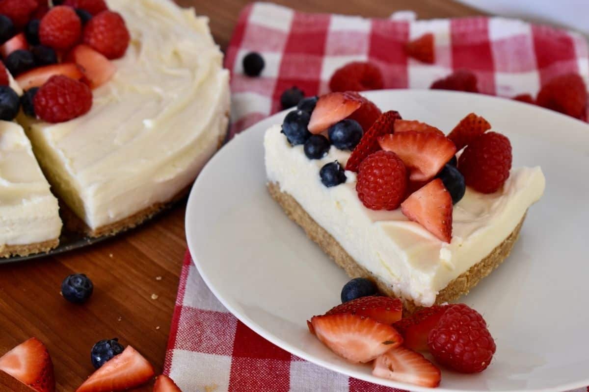 slice of no bake ricotta cheesecake on a white plate. 
