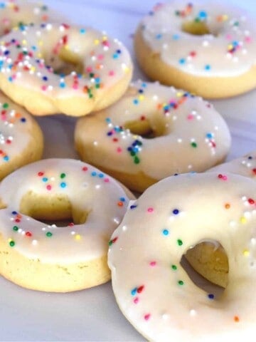 Taralli Dolci on a white countertop with sprinkles on them.