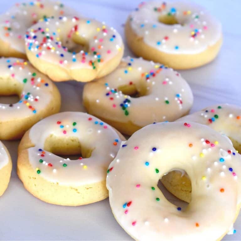 Taralli Dolci on a white countertop with sprinkles on them.