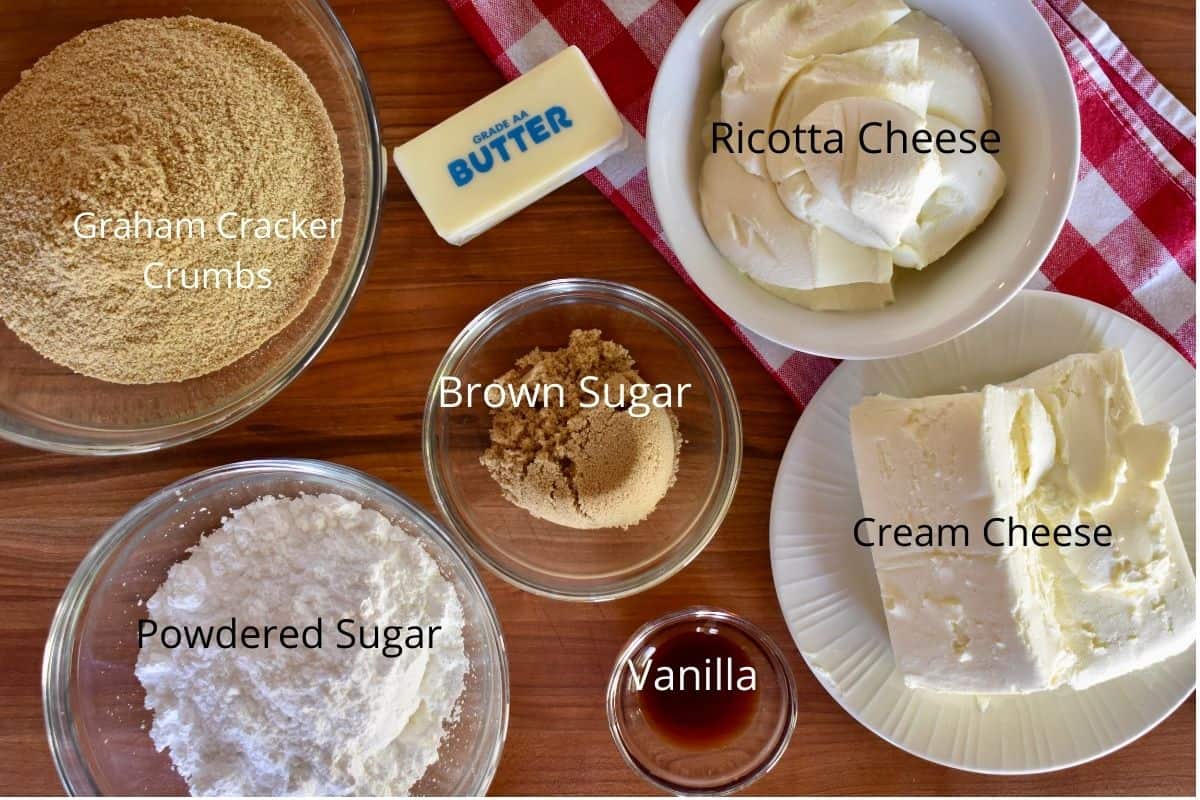 overhead photo of ingredients need to make the recipe including butter, powdered sugar, vanilla, and graham cracker crumbs. 